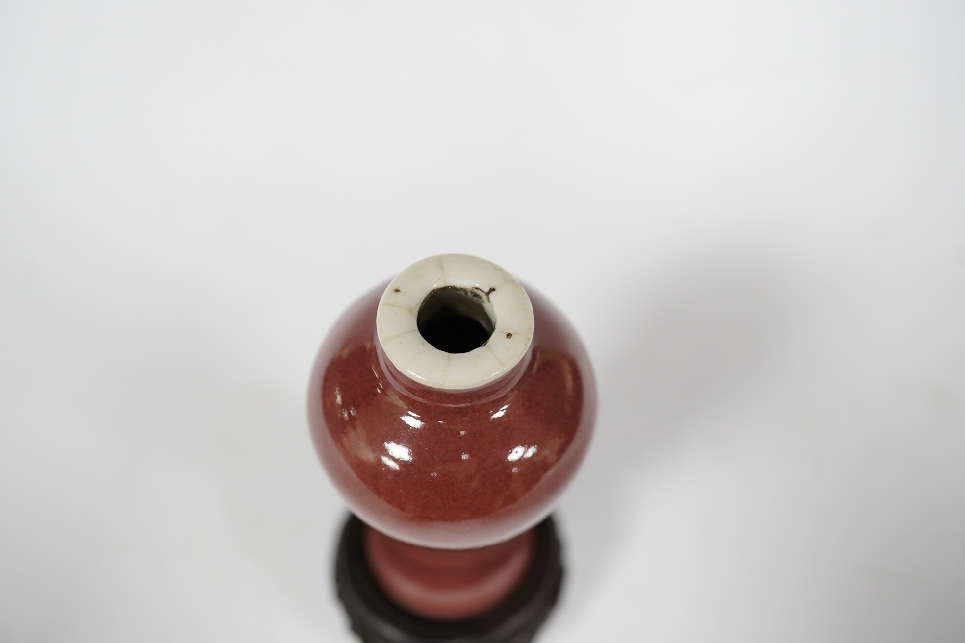 A Chinese Langyao snuff bottle, Kangxi mark, late 19th century, with hardwood stand, overall 10cm high. Condition - good, some crazing